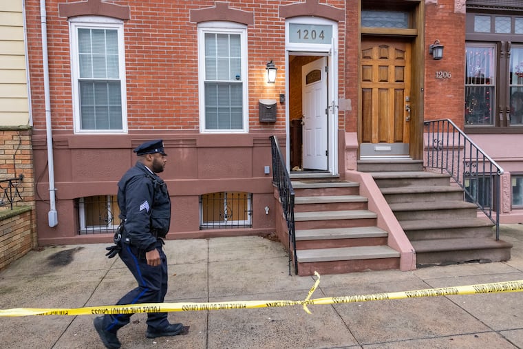 Philadelphia police hold the crime scene at rowhouse on 1200 block of Snyder Avenue on Dec. 23.