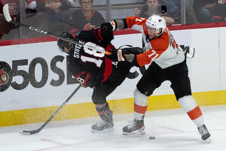 Flyers right wing Tyson Foerster (71) knocks Ottawa Senators left wing Tim Stutzle off the puck during the first period.