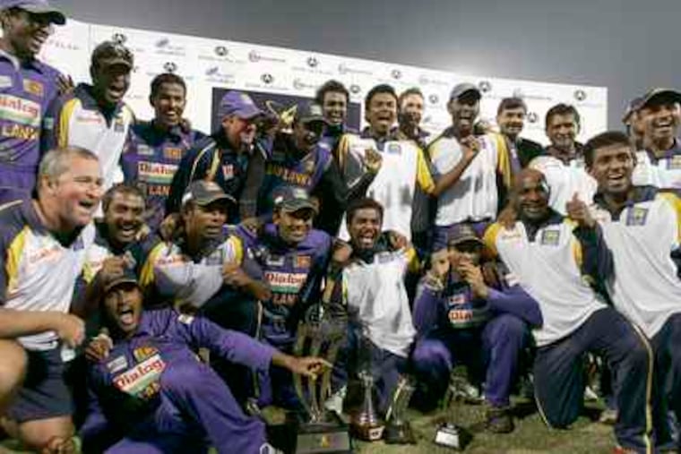 The Sri Lankan cricket team poses with the trophy it won in a January match against Pakistan. Besides the deaths of six police and one driver, seven players were hurt in Lahore yesterday.