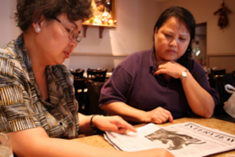 Gyaw and Mae read a Burmese newspaper yesterday. Myanmar's authoritarian government has cracked down on journalists, but grisly pictures and stories have seeped through the filter.