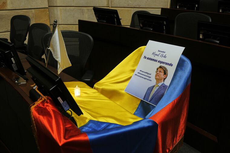 A leaflet showing Colombian Sen. Miguel Uribe Turbay sits on a Colombian national flag draped over his seat in the congressional chamber in Bogota, Colombia, on June 9, 2025.