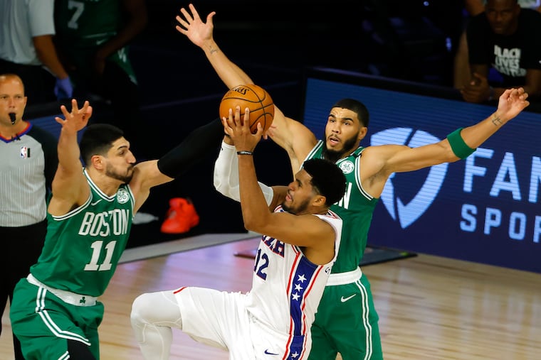 Tobias Harris drives against Jayson Tatum (right) and Enes Kanter in the first half.