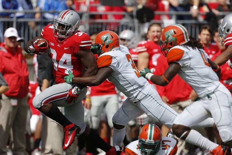 Ohio State's Carlos Hyde rumbles past Florida A&M defenders Devan Roberts and Akil Blount in the Buckeyes' most lopsided win since 1935.