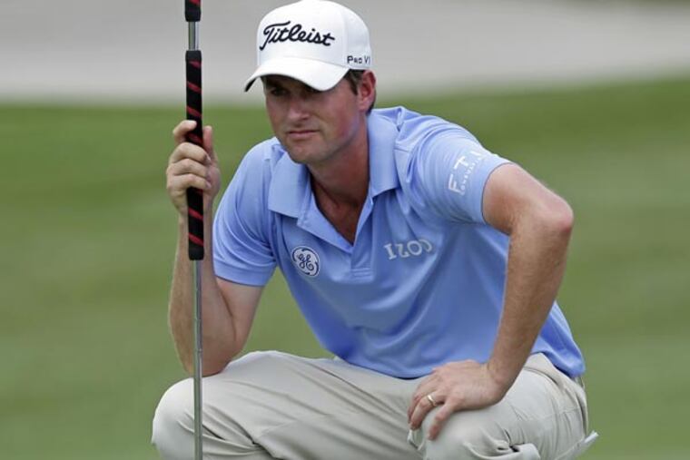 Webb Simpson looks over his putt on the second green during the third round of The Players championship golf tournament at TPC Sawgrass, Saturday, May 11, 2013, in Ponte Vedra Beach, Fla. (Chris O'Meara/AP)