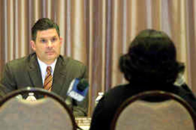 Assembly Budget Chairman Louis Greenwald listens to Gloria Crews as she speaks about her disabled 16-year-old daughter.