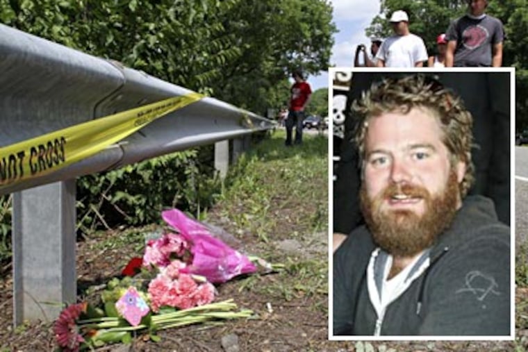 People visit the site along Rt. 322 where Ryan Dunn crashed his Porsche on Monday. (For the Inquirer and Daily News/ Joseph Kaczmarek, Scott Weiner)