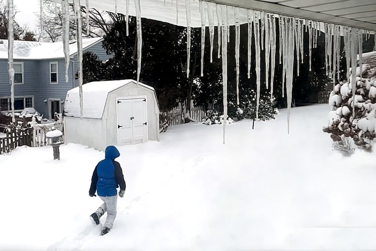 A child passes through a Haddonfield backyard Jan. 29, 2022, after a major nor’easter passed through the region late Friday night, leaving snow in South Jersey and blizzard conditions at the Shore.