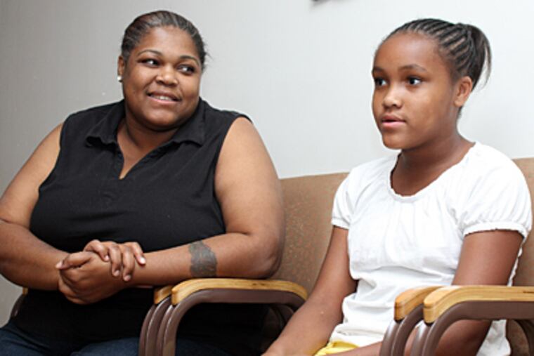 Ziainey Stokes (right), 11, with her mother, Zina Stokes, looking on, talks about a letter from President Obama in response to her complaint about bullying at her school.