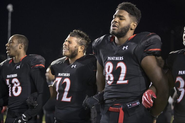 Dejected Imhotep Charter players after their 38-28 loss to Cathedral Prep. Arick Lochetto is second from left and Marquise Greenwood is third from left.