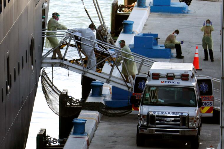 A person on a stretcher is removed from Carnival's Holland America cruise ship Zaandam at Port Everglades.