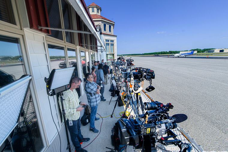 Members of the media line up for coverage of the arrival of immigrants at the Delaware Costal Airport in Georgetown, Del., on Tuesday.