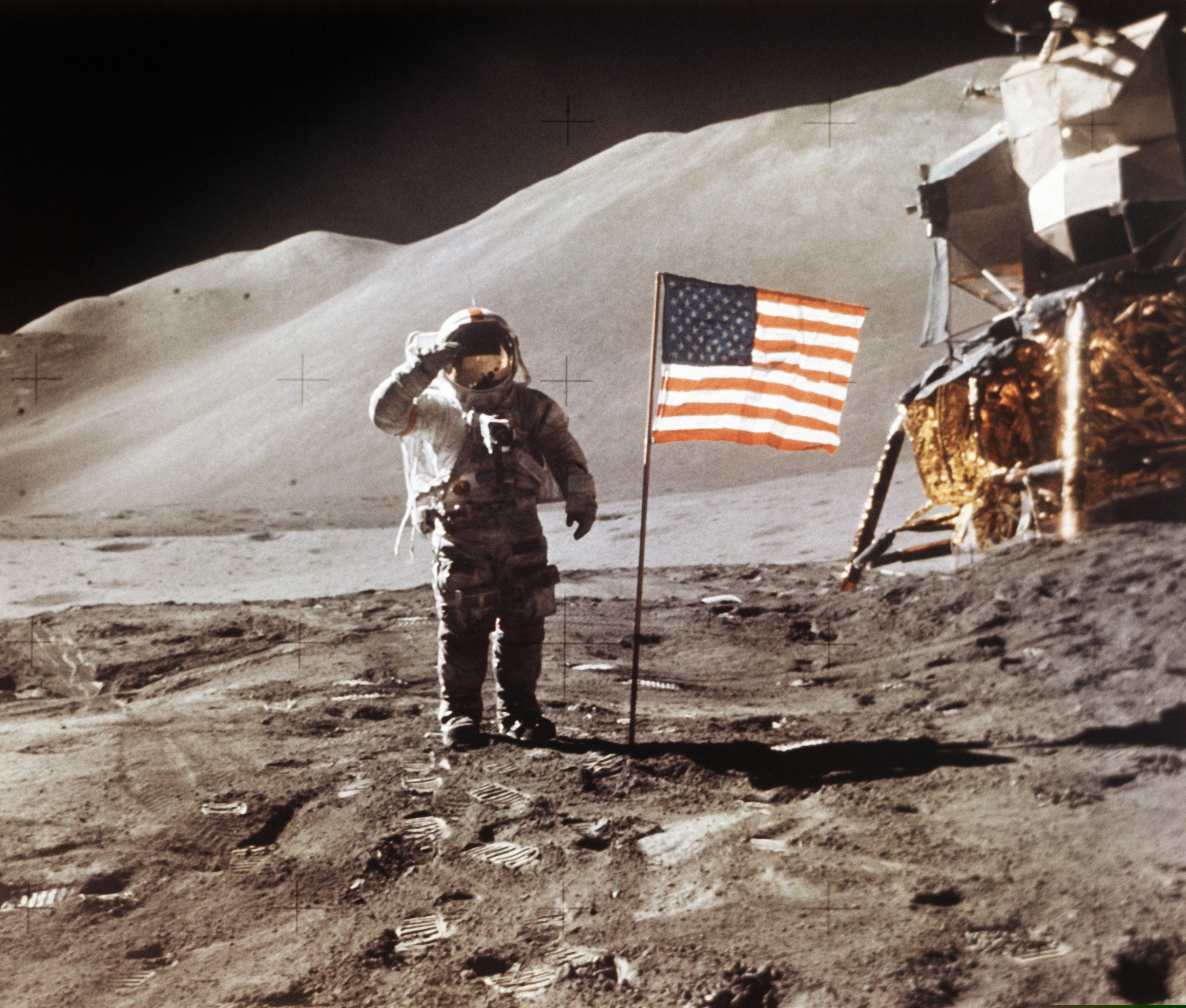 FILE - In this July 30, 1971 photo made available by NASA, Apollo 15 Lunar Module Pilot James B. Irwin salutes while standing beside the fourth American flag planted on the surface of the moon. On Tuesday, March 26, 2019, Vice President Mike Pence called for landing astronauts on the moon within five years. (NASA via AP)