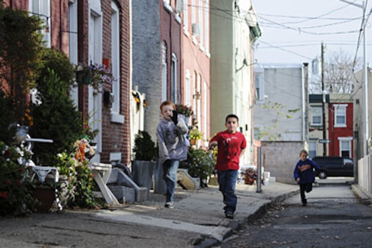 Michael Locke, 9, Timmothy Chase, 7, and Kyle Locke, 7 run down Gordon Street, which they helped clean. (Kriston J. Bethel / Staff Photographer)