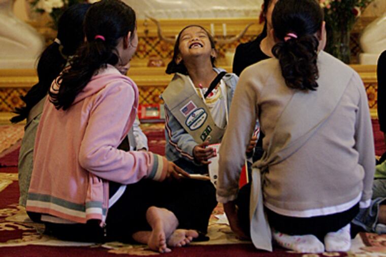 Molyna Sok, 5, shares a laugh with her fellow Girl Scouts during their meeting. (Michael Bryant / Inquirer)