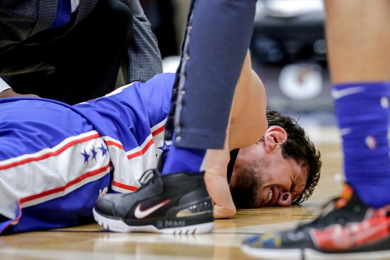 Sixers center Boban Marjanovic (51) winces in pain after being injured late in Monday's 111-110 victory over the New Orleans Pelicans.