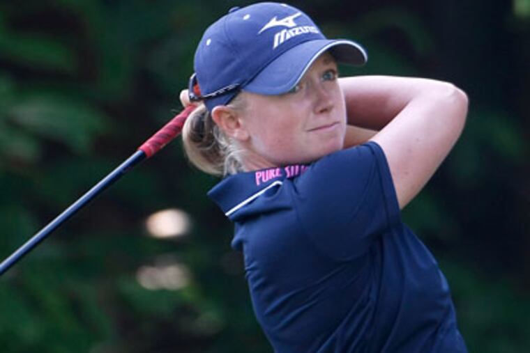 Stacy Lewis shot a 3-under 69 to keep the lead of the Evian Masters on Friday. (Claude Paris/AP)