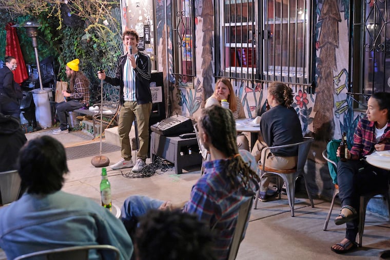 Ned Arnold (standing at left) hosts a comedy show at DAHLAK 4708 Baltimore Ave. in Phila., Pa. on Oct. 1, 2021.
