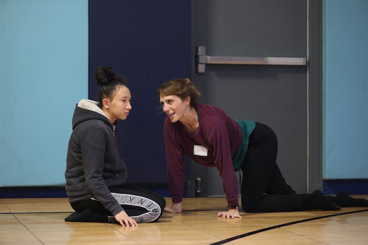 Trinity Brown is hesitant as Erin Carlisle Norton of Moving Architects dance troupe works with students at Valley Day School for emotionally troubled students. The group provides workshops for women and girls in trauma to express their feelings through dance.