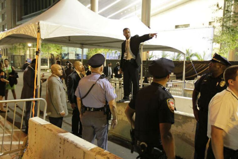 A security official speaks to attendees at the September 2012 Democratic National Convention in Charlotte, N.C. (AP File Photo)