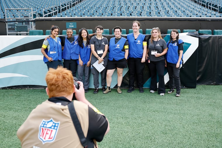 Eight women from the NFL Films crew take a group photo before the Eagles and Cincinnati Bengals' preseason game on Thursday.