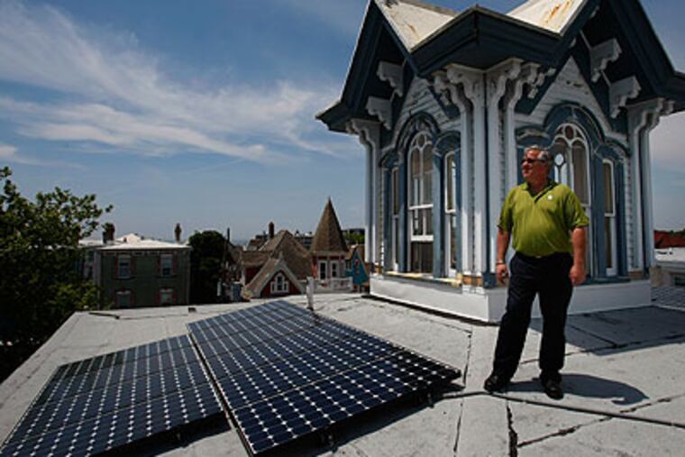 Mark Kulowitz, an owner of the Carroll Villa Hotel, next to newly-installed solar panels. The hotel is the first to have solar panels in the historic district of Cape May. (Michael S. Wirtz / Staff Photographer)