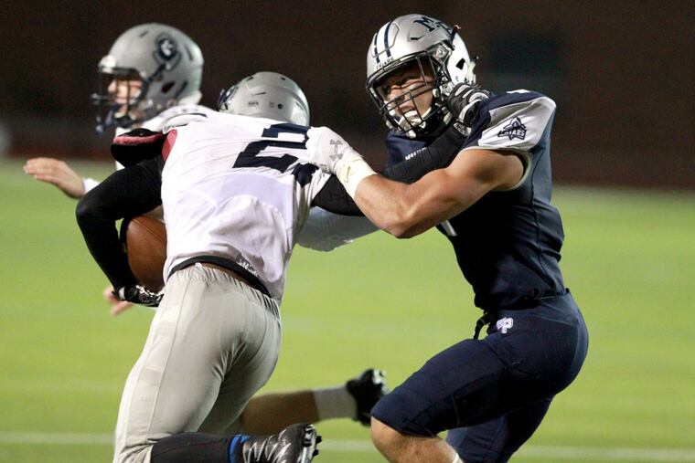 Malvern Prep’s Keith Maguire, right, brings down St. Augustine Prep’s True Robinson in last season’s opener at Villanova.