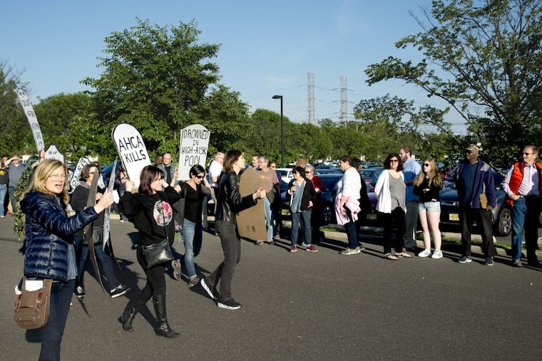 Protesters marched along a line of people waiting outside as U.S. Rep. Tom MacArthur held a town meeting in Willingboro last year.