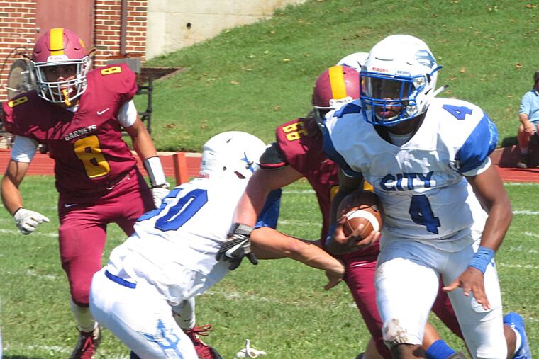 Burlington City's D.J. Woodbury (4) is a Temple football recruit but still has basketball on his mind.