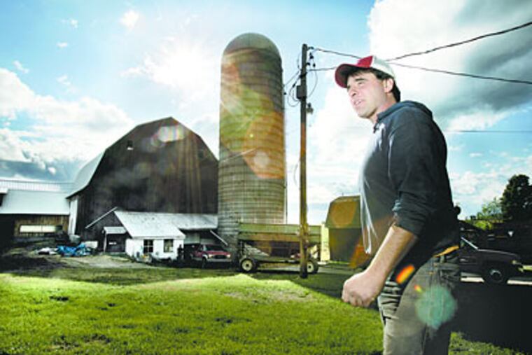 Dave Lichty on his farm near Mansfield, Pa. Lichty runs a dairy farm and is self employeed. He cannot afford health insurance for his family. (Laurence Kesterson / Inquirer)