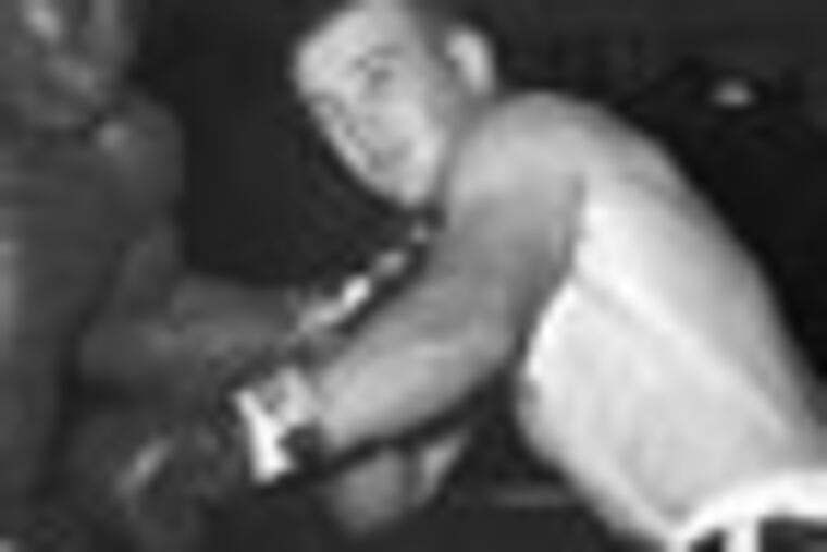 FILE - In this Sept. 12, 1964, file photo, former middleweight champion Dick Tiger, left, shakes up Don Fullmer with a hard left to the chin in a boxing bout in Cleveland. Fullmer, a former middleweight boxer who fought nine world champions and came within a fight of a world title himself, has died in Utah at the age of 72. His sons told the Deseret News that he died Saturday, Jan. 28, 2012, in West Jordan, Utah, after suffering from lymphocytic leukemia for 15 years. (AP Photo/Paul Shane, File)