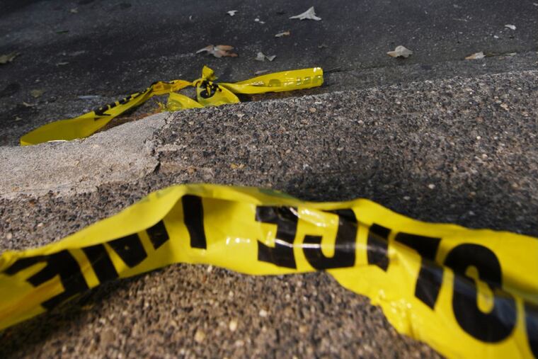 Pieces of police crime scene tape in Philadelphia. DAVID MAIALETTI/Staff Photographer