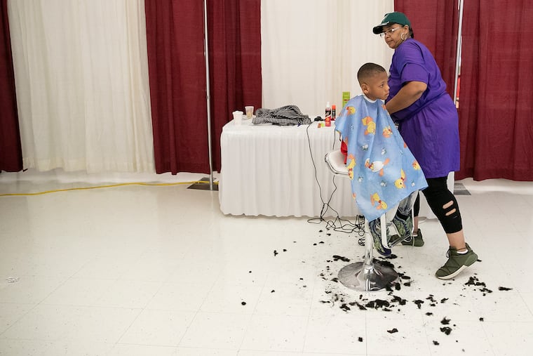 Qadir Harris, 6, has his hair cut by Tracey Lang.