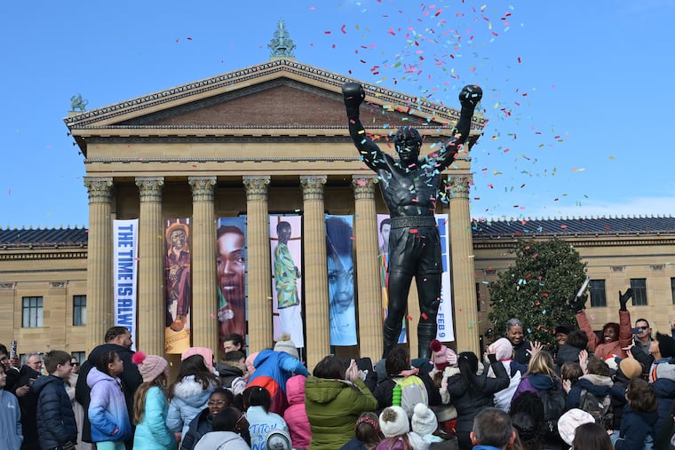 People gather around the "Rocky" statue at the Philadelphia Museum of Art on Dec. 3, 2024, during a ceremony kicking off the first Rocky Festival in Philadelphia.