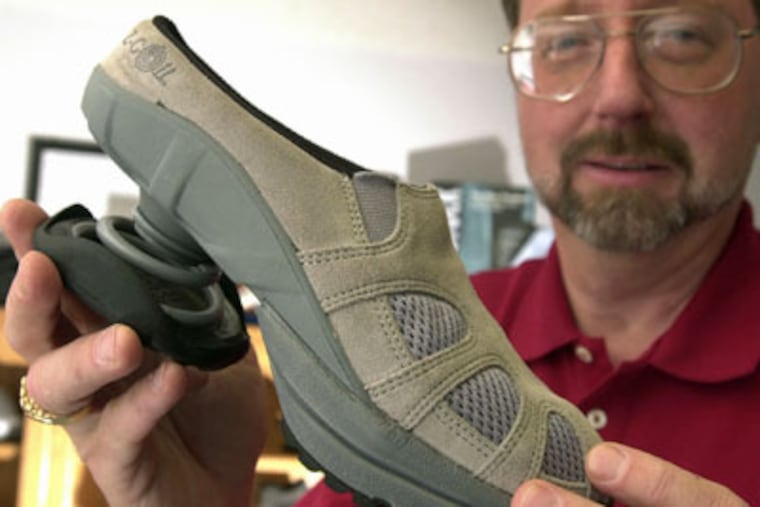 John Mishasek sells Z-Coil shoes at his store in Colorado Springs, Colo. The shoe has a big spring in the heel. (Carol Lawrence / Colorado Springs Gazette)