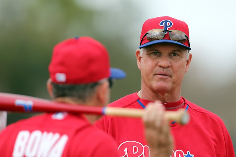 Former Phillies manager Ryne Sandberg talking with coach Larry Bowa during 2014 spring training in Clearwater, Fla.