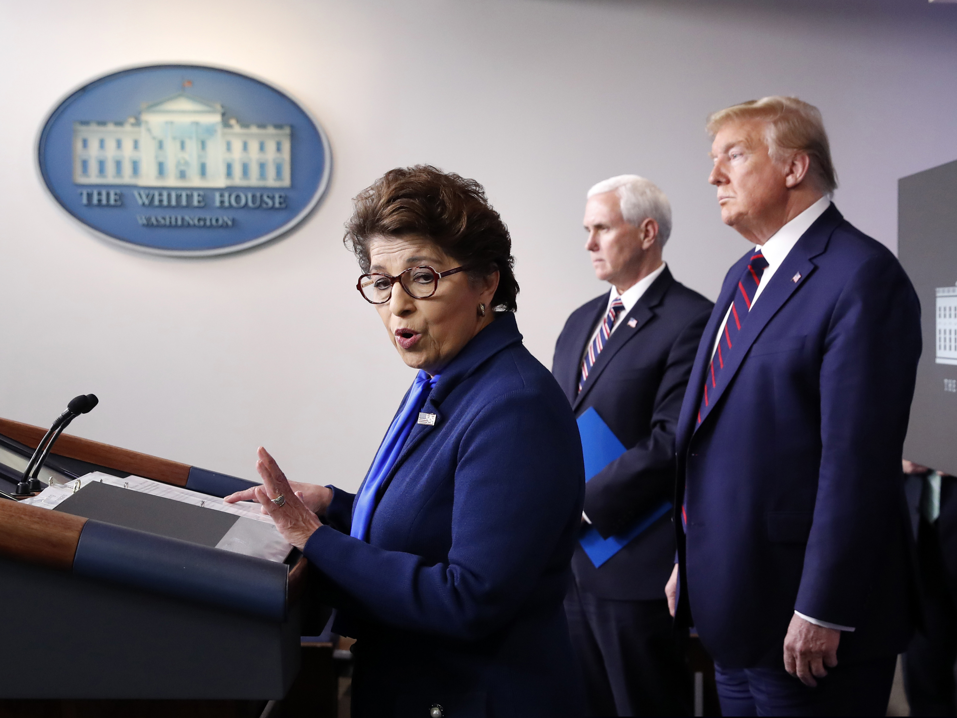 Jovita Carranza, administrator of the Small Business Administration, speaks about the coronavirus Thursday as Vice President Mike Pence, President Donald Trump listen.