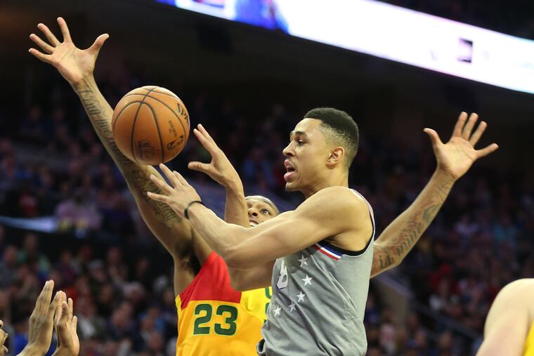 Zhaire Smith of the Sixers passes to a teammate after driving the lane against the Bucks at Wells Fargo Center during the 1st half on April 4, 2019.