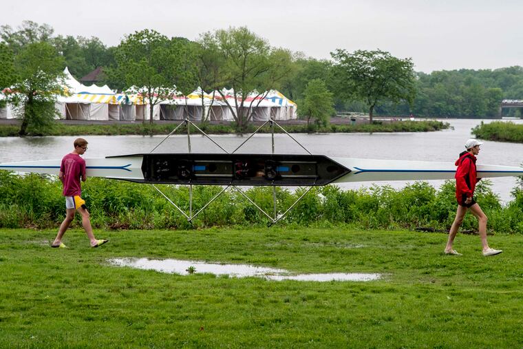 Nicholas Kumpf (left) and James Cepis with Roman Catholic High School in Philadelphia carry their double shell to practice on the Cooper River after last year's Stotesbury Cup Regatta switched venues because of high water on the Schuylkill. This year, the Murphy Cup regatta for college rowers is making a similar move.