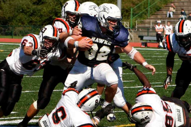 Council Rock South running back Matt Damirgian draws a crowd of Pennsbury defenders on a second-half run. Damirgian rushed for 127 yards and scored two touchdowns. He added a third TD on a 12-yard pass from QB Billy Flemming, giving him 18 of his team's 24 points.