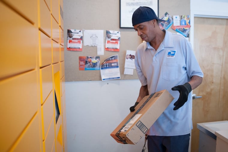 Lawrence Chandler, a USPS postal worker who works at the William Penn Annex at 9th and Market, delivers packages to an Amazon Locker at the Quick Clean Laundromat at the corner of 10th and Spruce Streets.