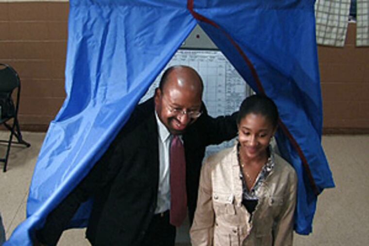 Democratic mayoral candidate Michael Nutter emerging from the voting booth this morning.
