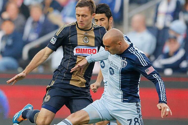 Sporting Kansas City defender Aurelien Collin (78) blocks the progress of Philadelphia Union forward Andrew Wenger during the first half of an MLS soccer match in Kansas City, Kan., Wednesday, May 14, 2014. (Orlin Wagner/AP)