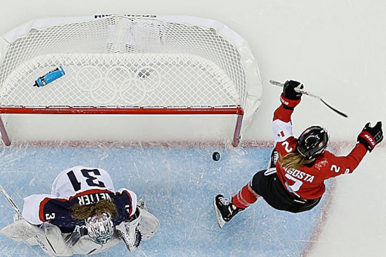 Meghan Agosta-Marciano of Canada celebrates her goal as USA goalie Jessie Vetter looks down at the ice in the third period. (Julio Cortez/AP)