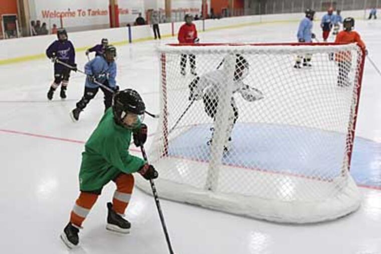 A memebr fo the Pennsauken Knights skates the puck behind his net to clear it during a mini tournament held between the Snider Hockey Clubs on November 10, 2012. Saturday marks a big day for inner-city hockey. There are now four rinks open all year. To mark the opening of Tarken in Oxford Circle, kids will hit the ice for a hockey tournament. The public comes in on Sunday. Project of Snider Foundation
Time to come Looking for shots of children and others enjoying the newly renovated Tarken ice rink, the last of 4 in the city to get a facelift thanks to the Snider Foundation ( MICHAEL BRYANT / Staff Photographer )