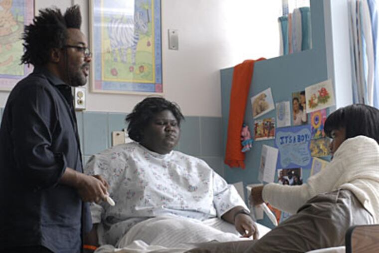 Lee Daniels, left, with Gabourey Sidibe, center, and Xosha Roquemore on the set of "Precious." Daniels, a Philadelphia native, is the first African-American to be nominated for best director.