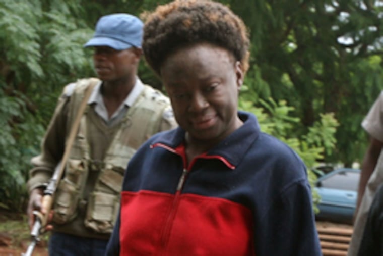 Jestina Mukoko , who had been missing for three weeks, is led into court Wednesday. She reportedly is missing again.