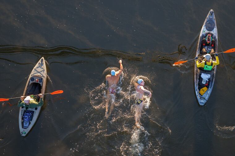 Swimmers Mason Beck, of Cleveland, Ohio, (left) and Stephen Rouch, of Kingston, Pa., lead the start of the 15k event in the Schuylkill during French Creek Racing's Charles Bender Memorial Swim.