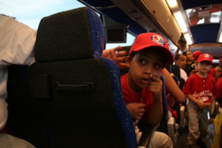 Jordi Torres , 6, looks toward the back of the bus after leaving Camden for Washington. The youngsters from the Cramer Hill T-ball team got to show off their skills at the White House.