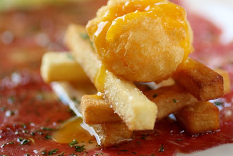 The Fountain's witty take on steak and eggs, left, is beef carpaccio topped with crisp Pont Neuf potatoes and tempura-fried egg yolk. (Michael Bryant/Staff Photographer)