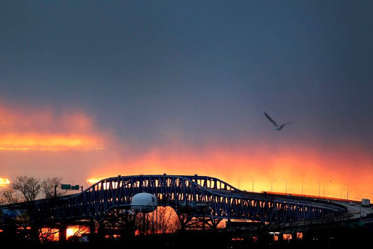 The suns sets behind the Girard Point bridge as the Philadelphia Flyers play the New York Rangers in the 2012 Bridgestone NHL Winter Classic at Citizens Bank Park in Philadelphia on January 2, 2012. ( David Maialetti / Staff Photographer )